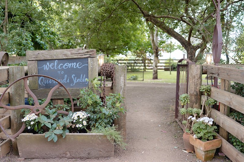 Welcome sign with florals at entry to Quirindi Stables wedding