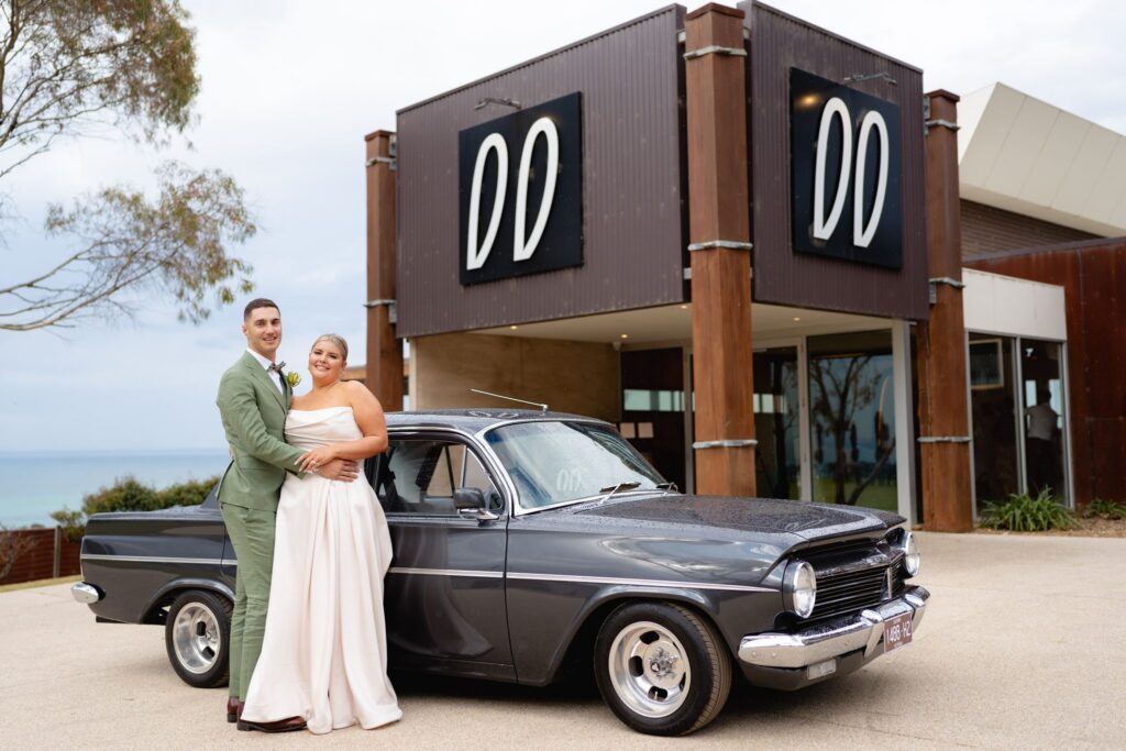 Bride and groom beside a vintage car outside Jack Rabbit Vineyard, Bellarine Peninsula