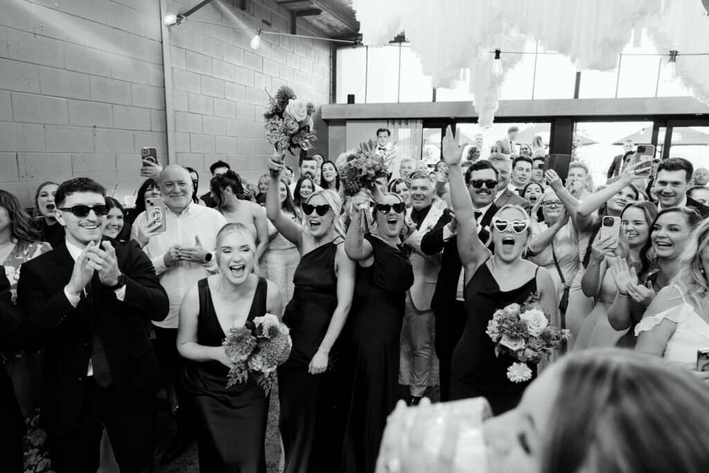 Black and white group photo with sunglasses at Industry26 wedding reception