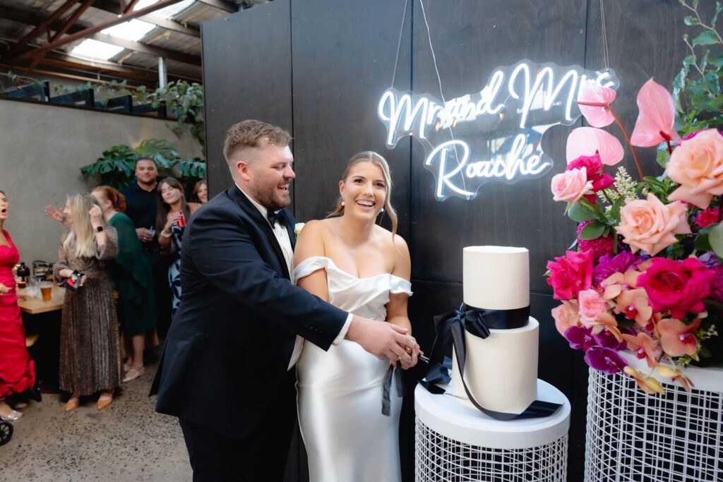 Bride and groom cutting the cake at Industry26 wedding reception