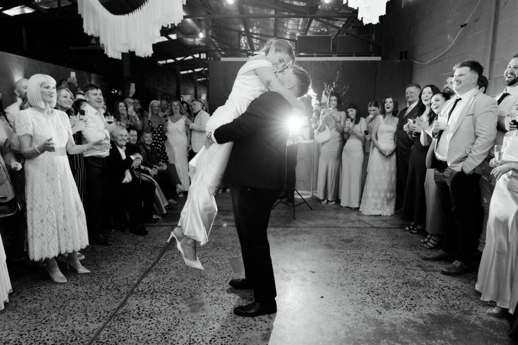 Black and white photo of first dance dip at Industry26 wedding reception