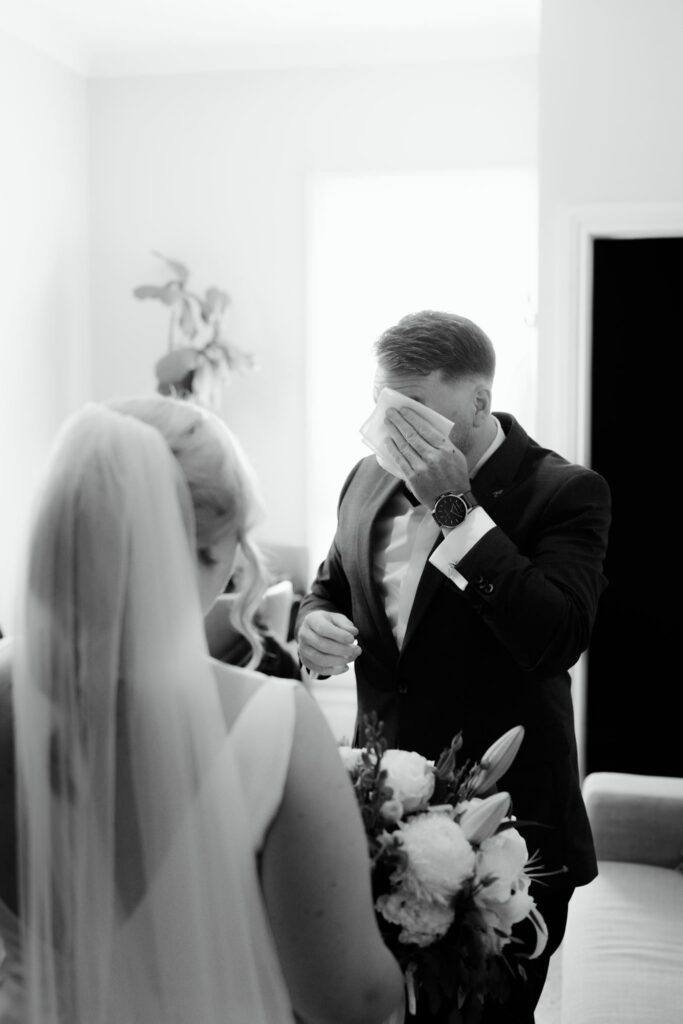 Black and white photo of emotional brother and sister moment before Witchmount Estate wedding