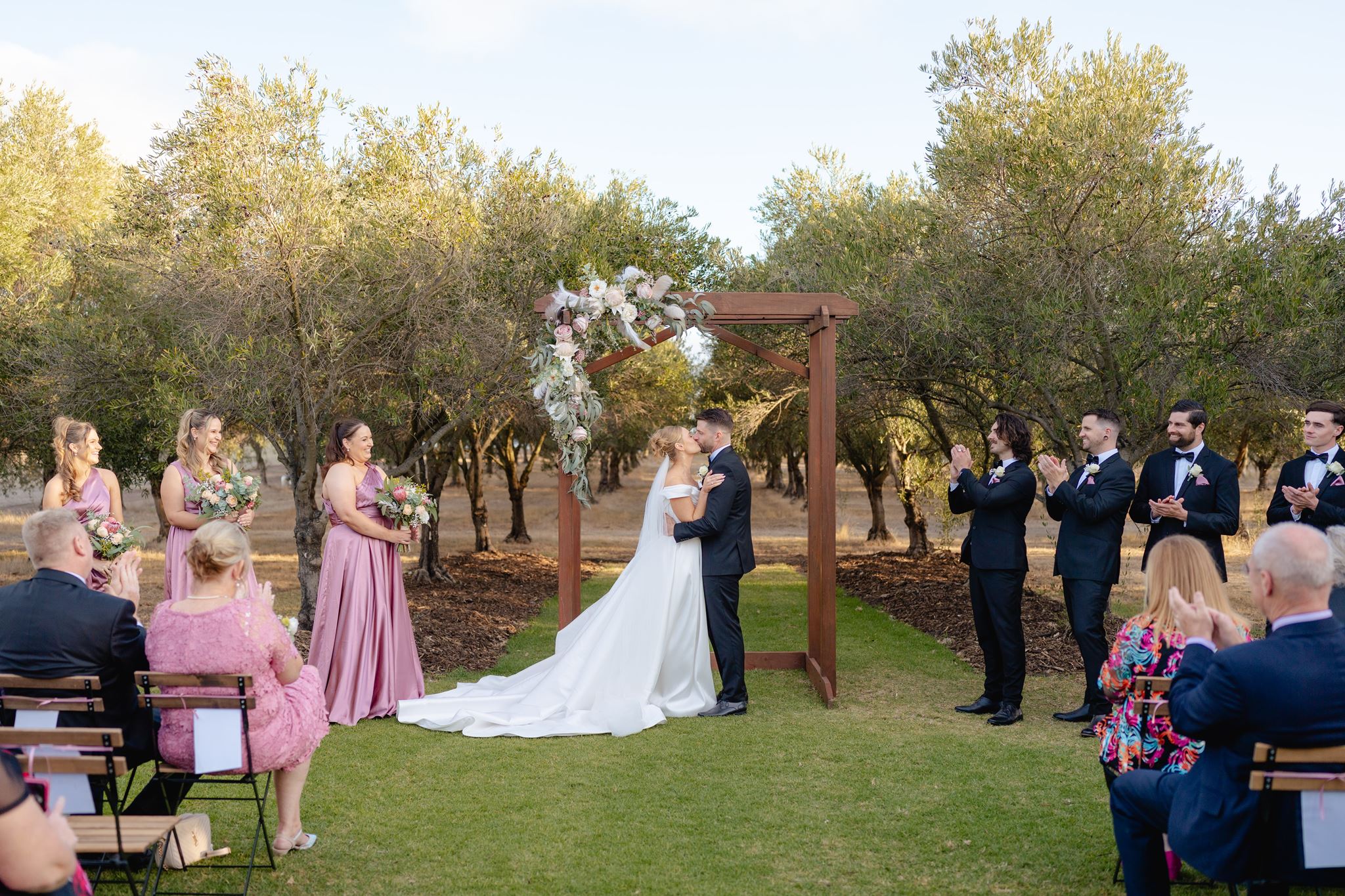 Jess and Michael's first kiss in the Olive Grove at Mount Duneed Estate
