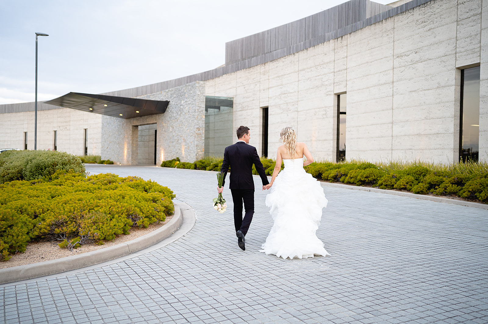 Bride and groom walking at RACV Torquay Resort, Surf Coast wedding venue