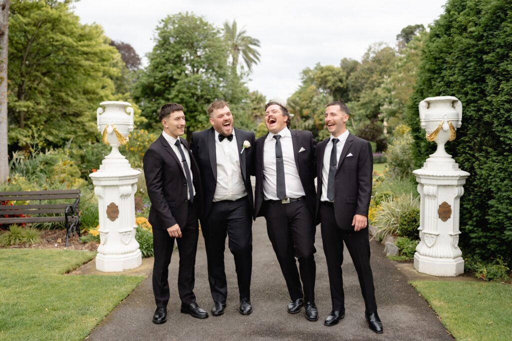 Groomsmen group portrait among garden urns at Geelong Botanic Gardens wedding