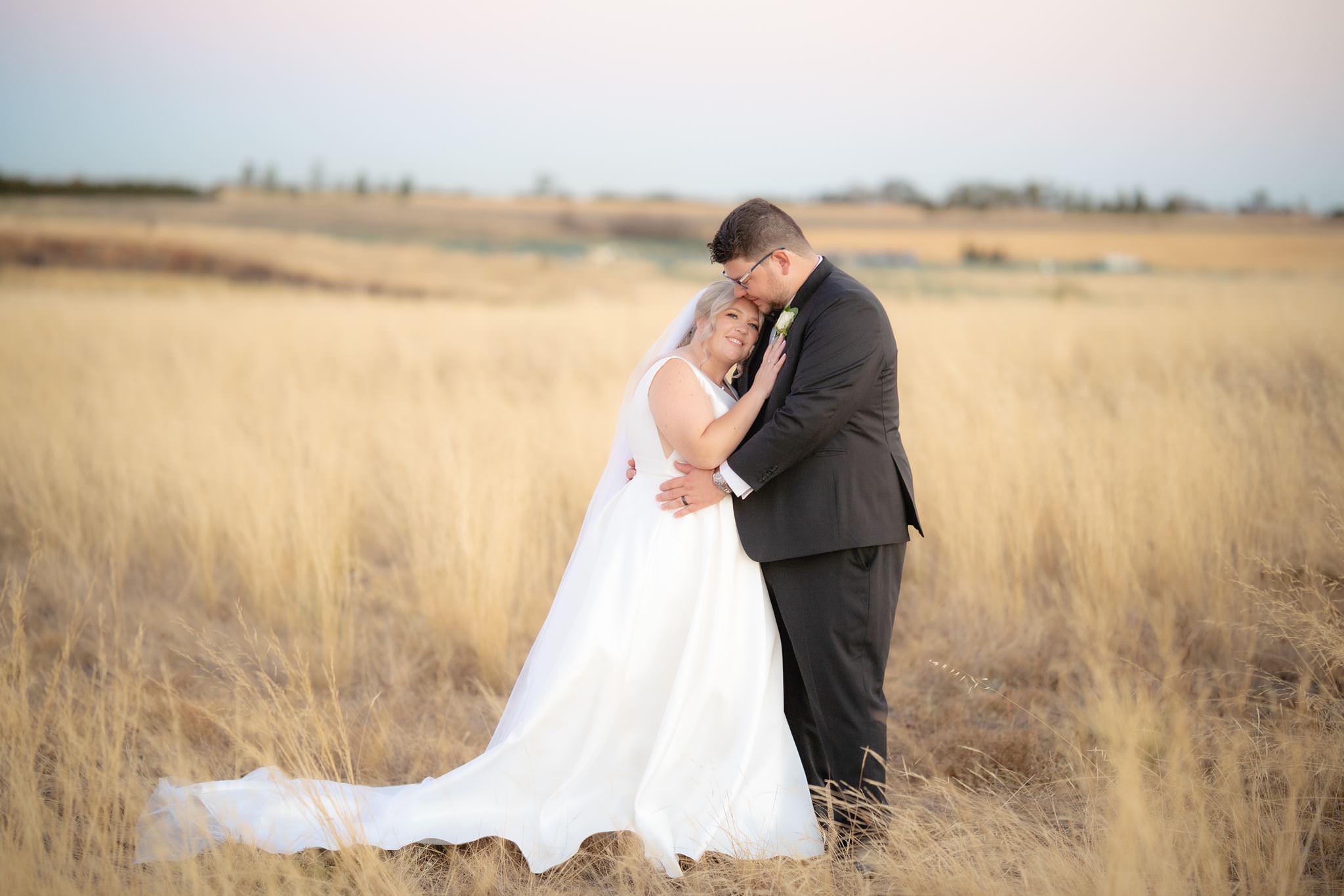 Bride and groom final portrait in the field at dusk, Witchmount Estate wedding