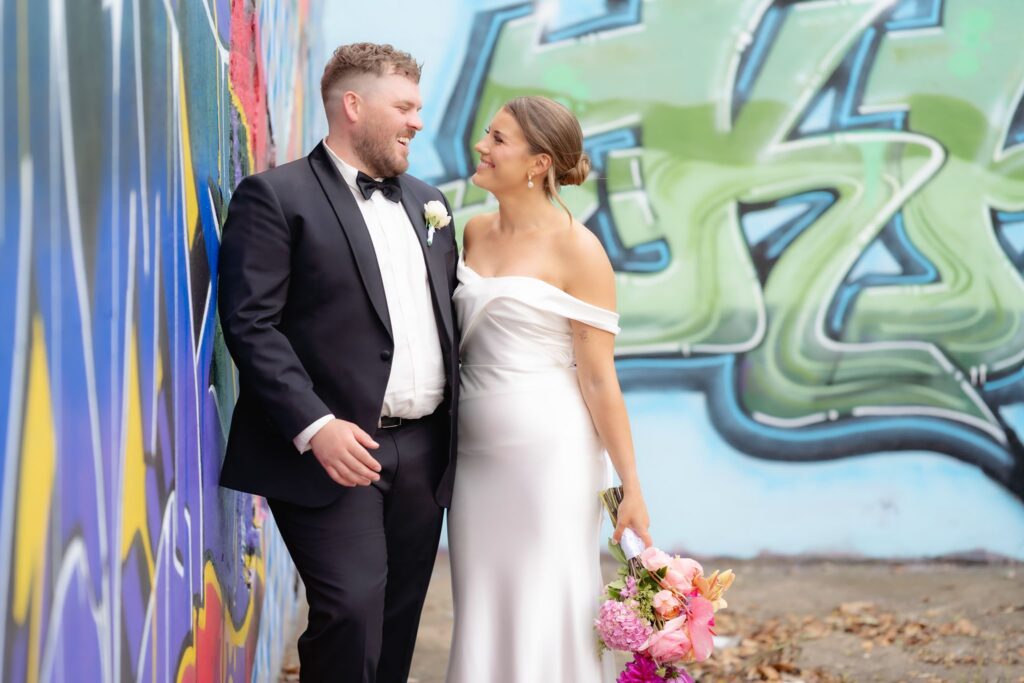 Bride and groom portrait against a colourful mural in Geelong West