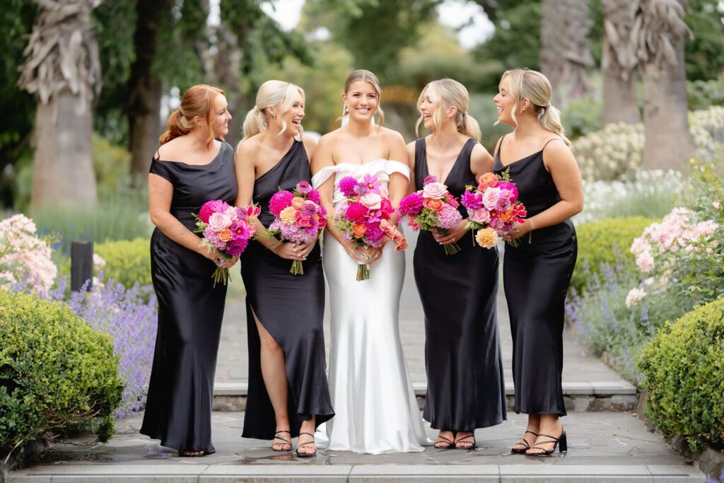 Bridesmaids group portrait with pink bouquets in the garden at Geelong Botanic Gardens wedding