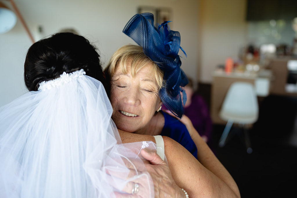 Mother of the Bride hugging her daughter before the wedding at the Batesford Hotel.