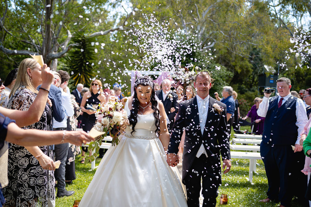 The guests throw confetti at the newlyweds at their Batesford Hotel Wedding